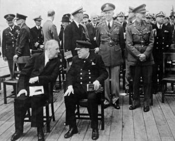 U.S. President Franklin D. Roosevelt and British Prime Minister Winston Churchill meeting aboard the HMS Prince of Wales somewhere at sea, issued a joint declaration setting forth certain common priniciples held by their two countries on which they based their hopes for a better world future. 